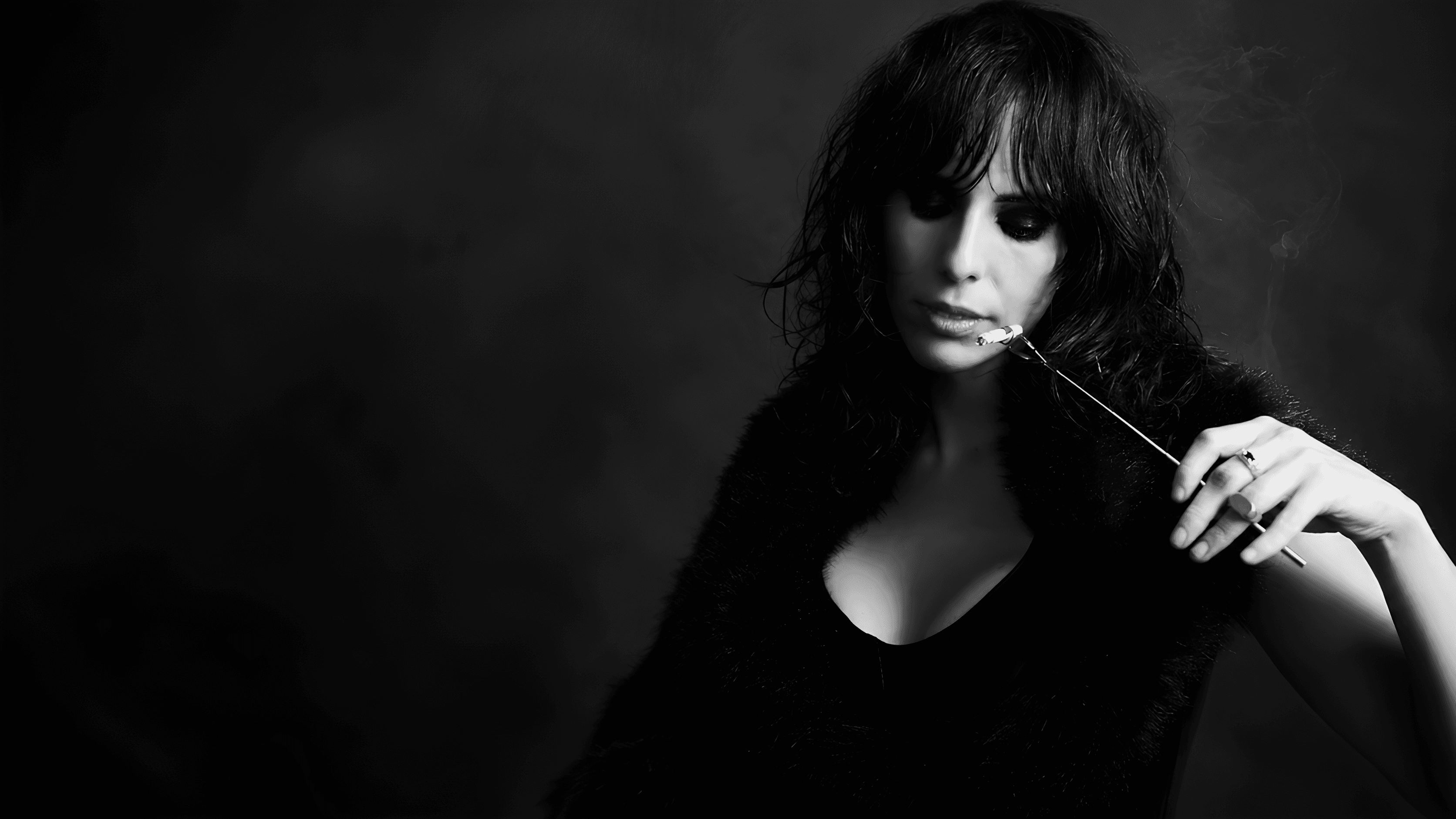 Black-and-white editorial portrait of EMINATR1X holding a cigarette holder